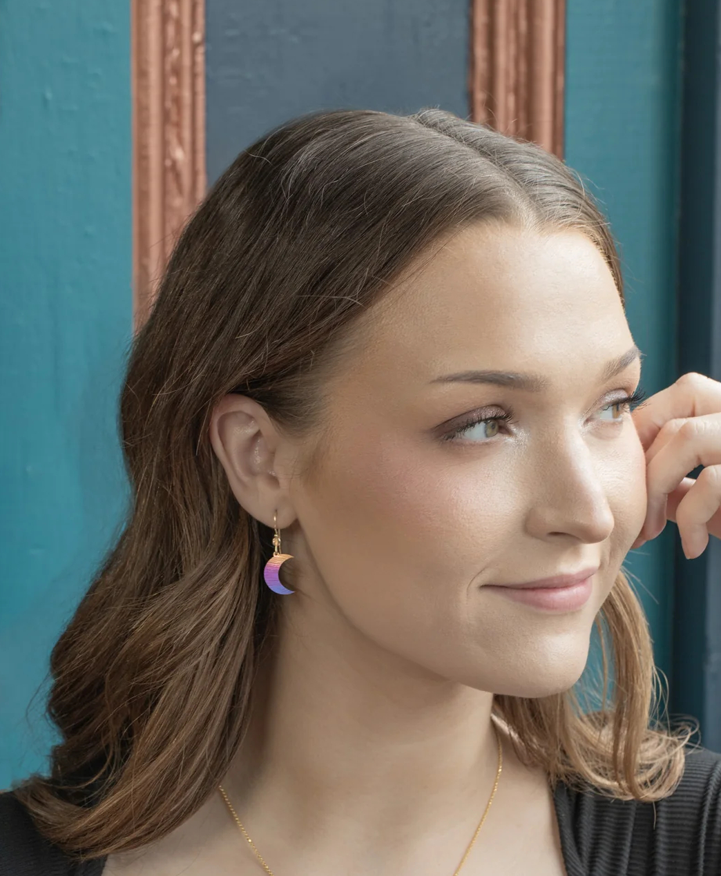 multicolor sun and moon earrings on model