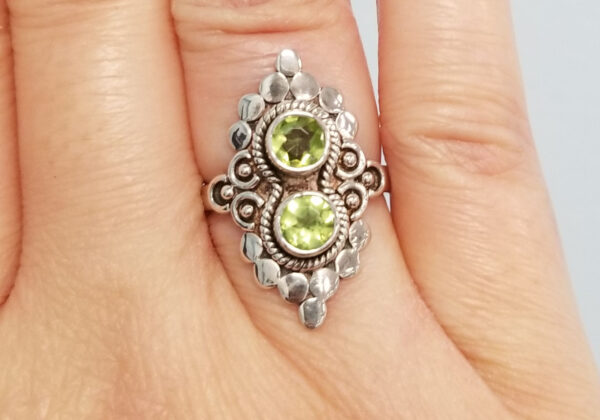 peridot and sterling silver ring on hand