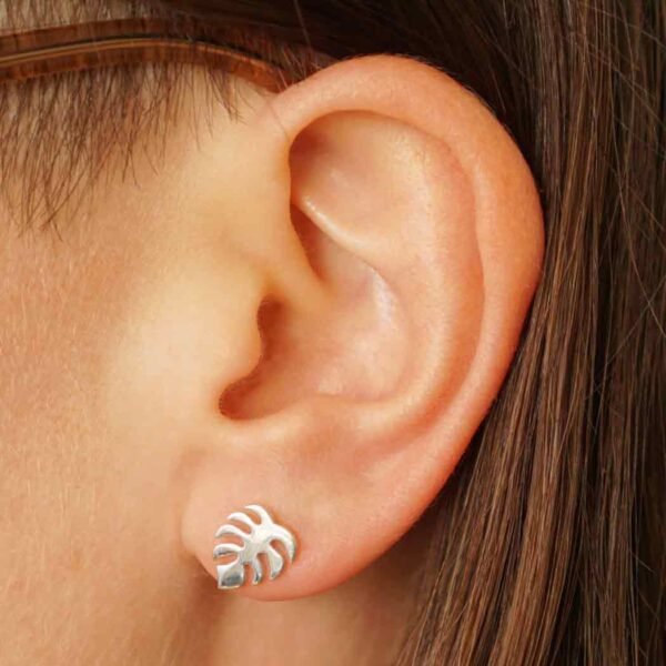 monstera leaf stud earrings on ear