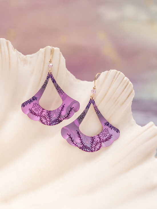 purple sea inspired earrrings on shell