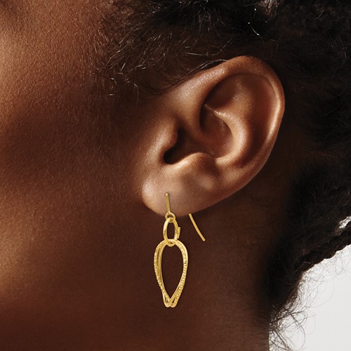 gold earring on model
