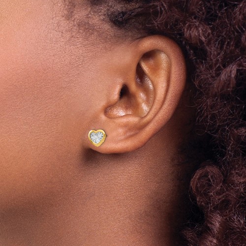 two tone heart post earrings on model