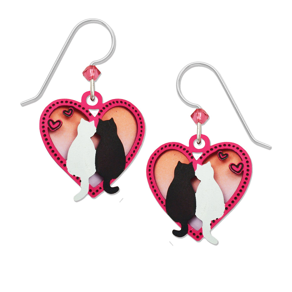 cat earrings featuring a black cat and a white cat inside a heart