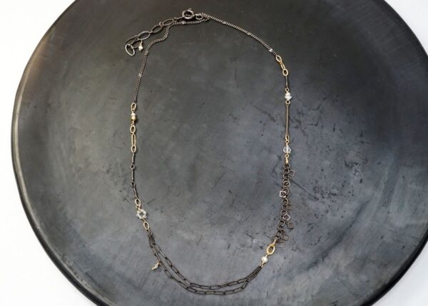 dainty mixed metal necklace with pearl and quartz accents