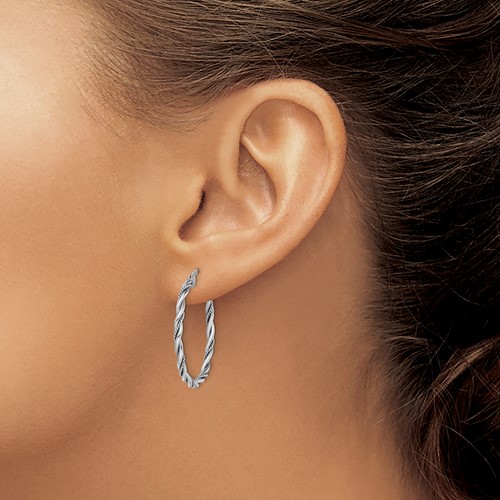 Twisted rope design sterling silver hoop earrings on model