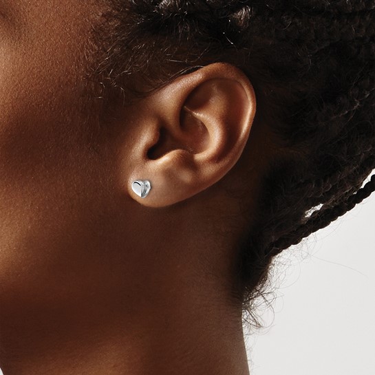 petite diamond heart stud earrings on woman