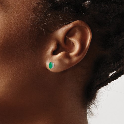 emerald stud earrings on ear