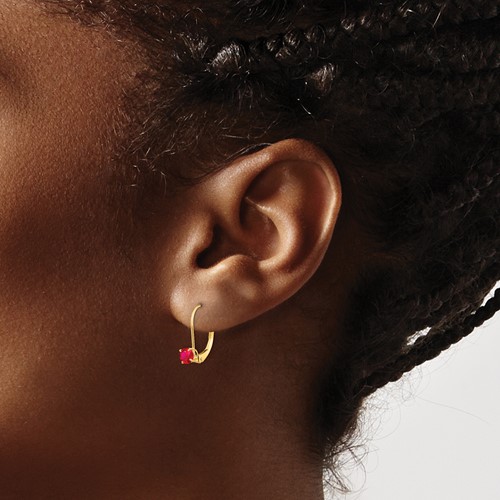 small ruby and gold earring on model