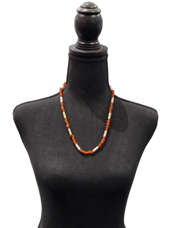 amber and mother of pearl necklace on dress form