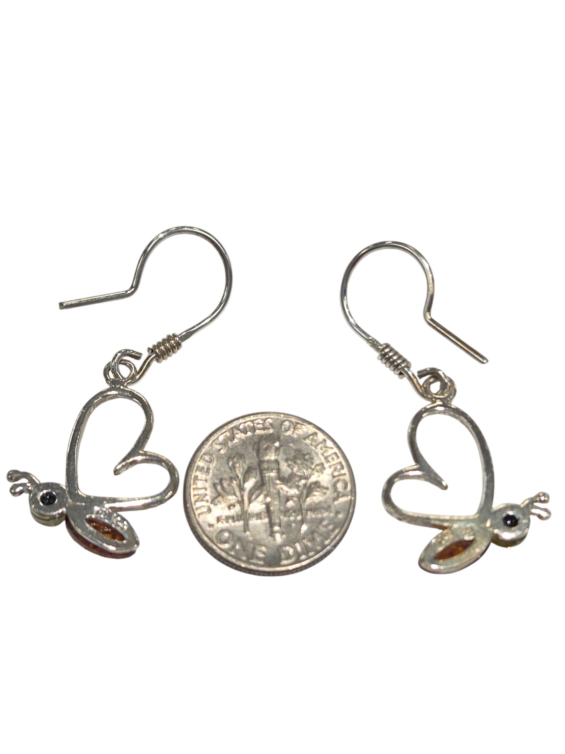 backside of butterfly earrings with dime for size comparison