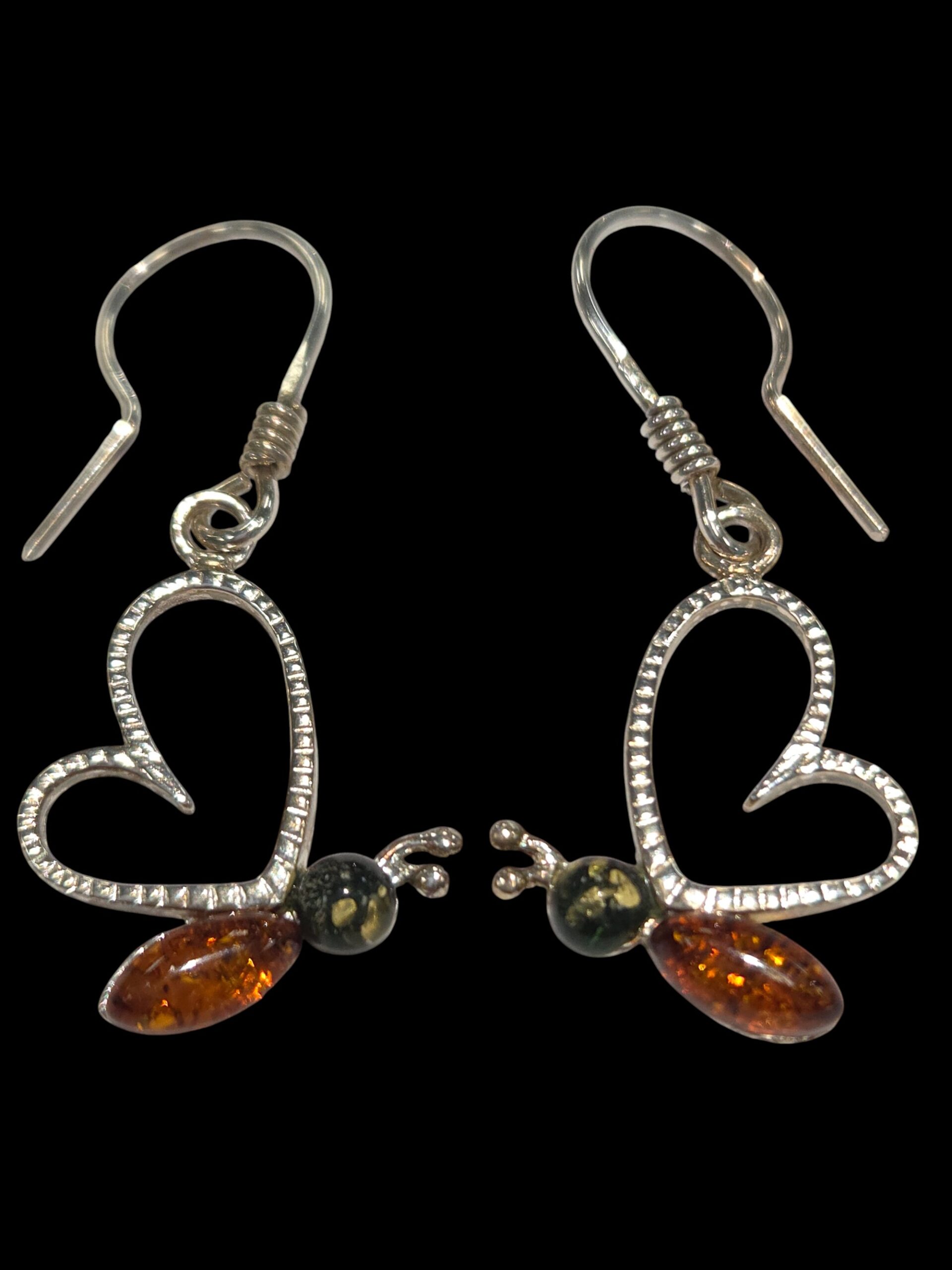 green and honey amber butterfly earrings with black background