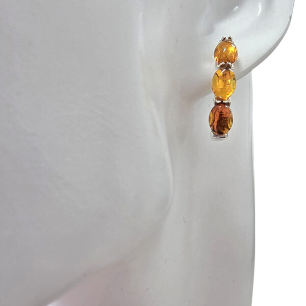 Baltic amber hoop earrings on ear