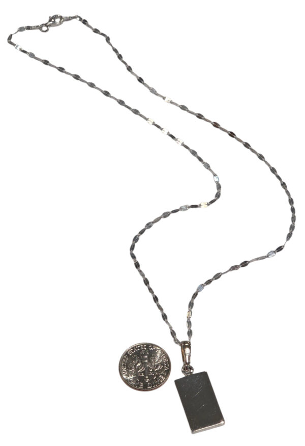 backside of necklace with dime for size comparison