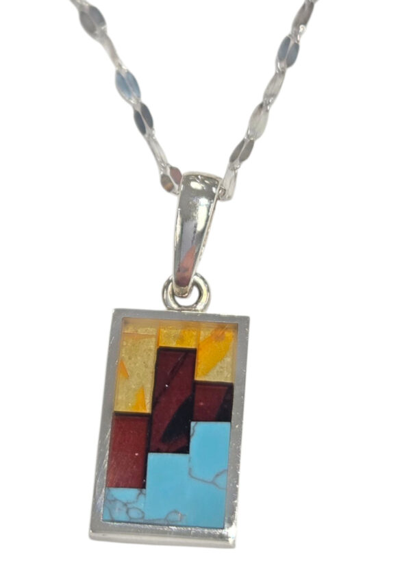 close-up of lemon amber, cherry amber, and turquoise inlaid necklace