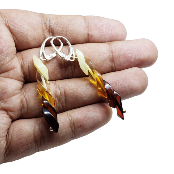 light to dark amber earrings in hand