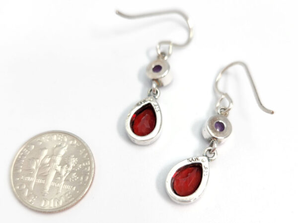 Backside of amethyst and garnet earrings with dime for size comparison