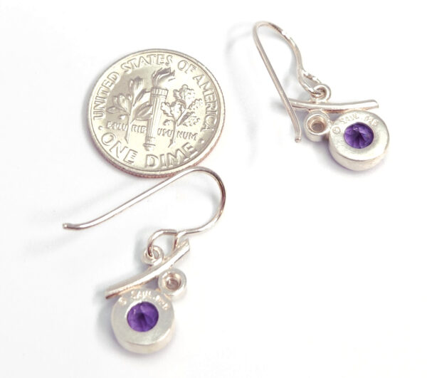 Backside of amethyst earrings with dime for size comparison