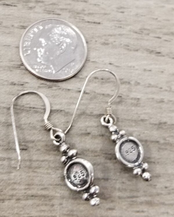 back of stone inlay earrings with dime for scale