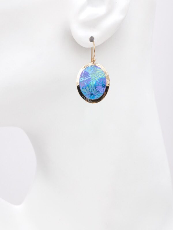 blue and purple oval mod flower earrings on model