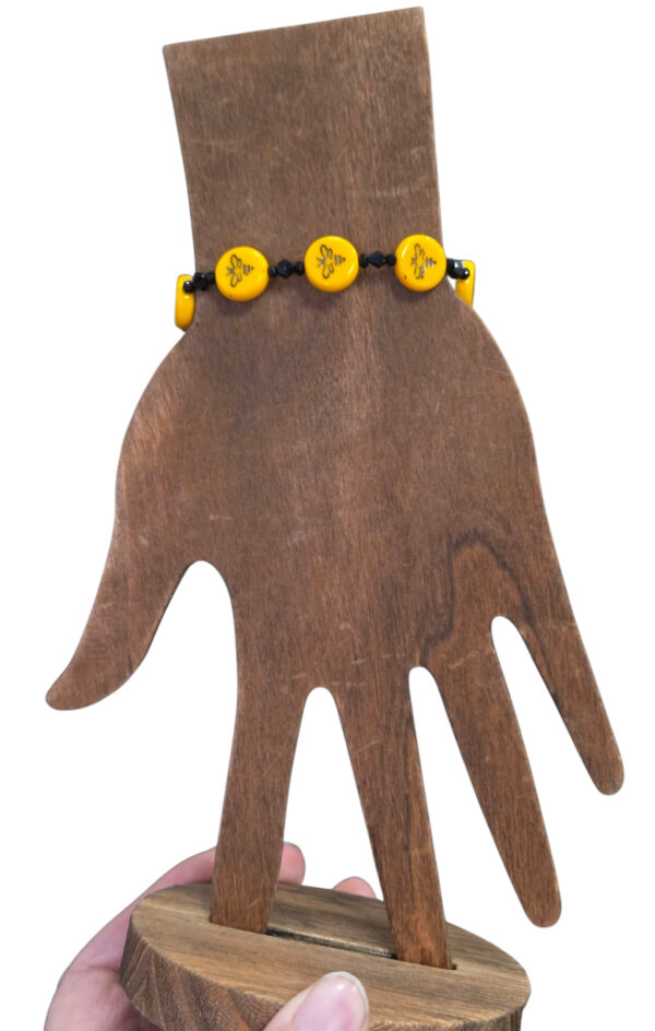 handmade dainty bee bracelet on hand form