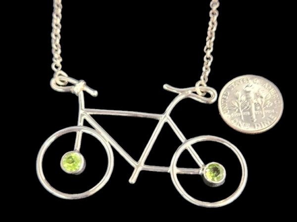 bike necklace with dime for size comparison