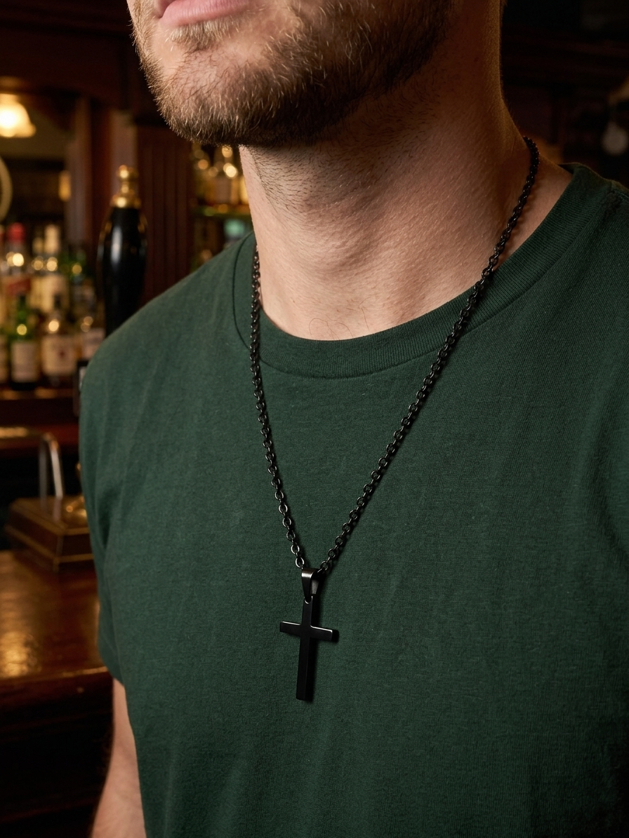 man wearing black stainless steel cross necklace