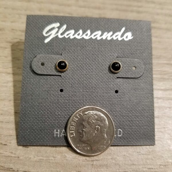 black enamel and sterling silver stud earrings on card with dime for scale