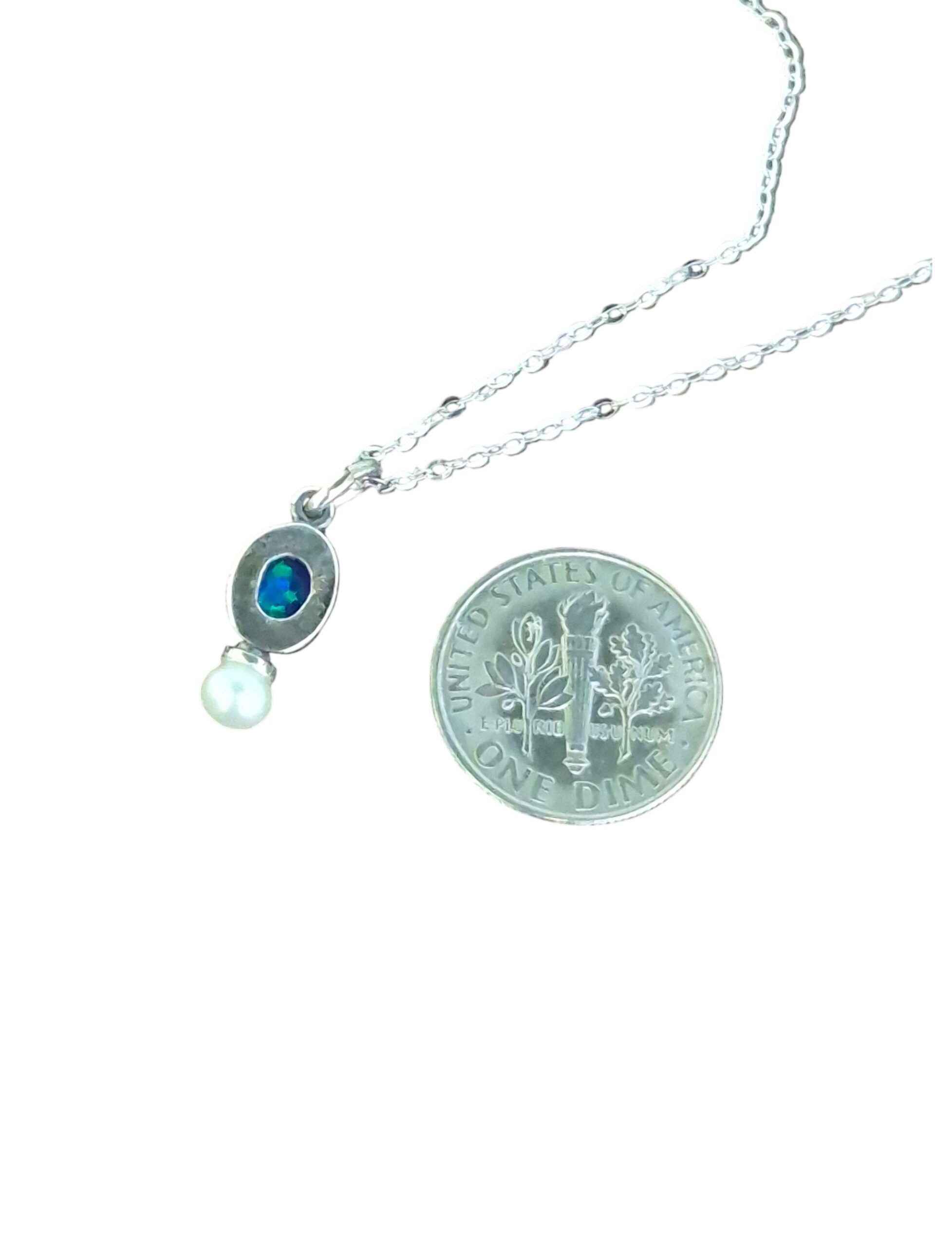 backside of opal and pearl necklace with dime for size comparison