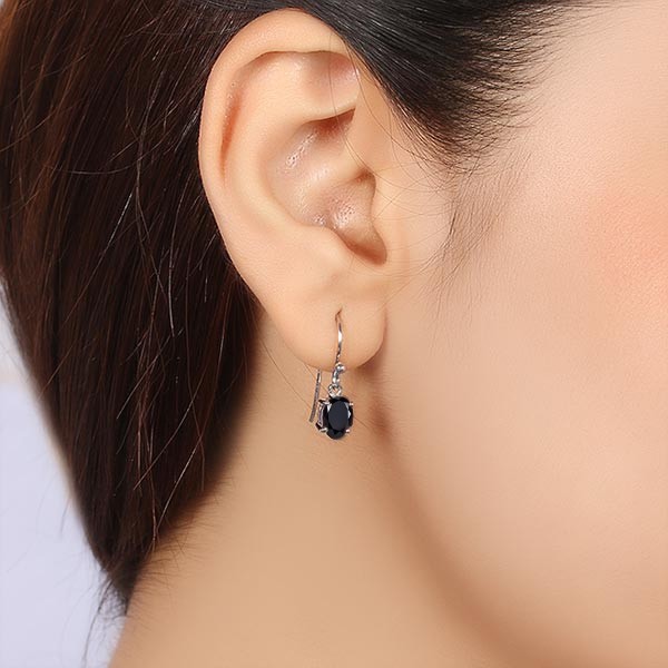 black spinel earrings on model