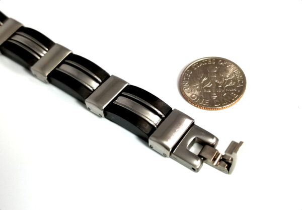 black and stainless steel bracelet, close-up of fold-over style clasp with dime for scale