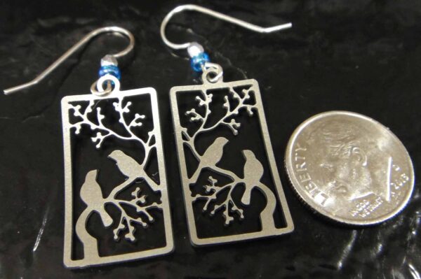 back of blue bird earrings with dime for scale