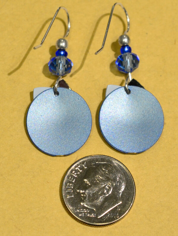 back of blue circle with silvertone triangle Adajio earrings with dime