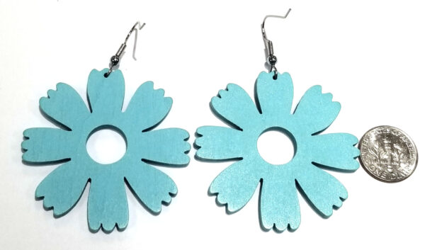 back of large light blue wooden flower earrings with dime to help judge scale