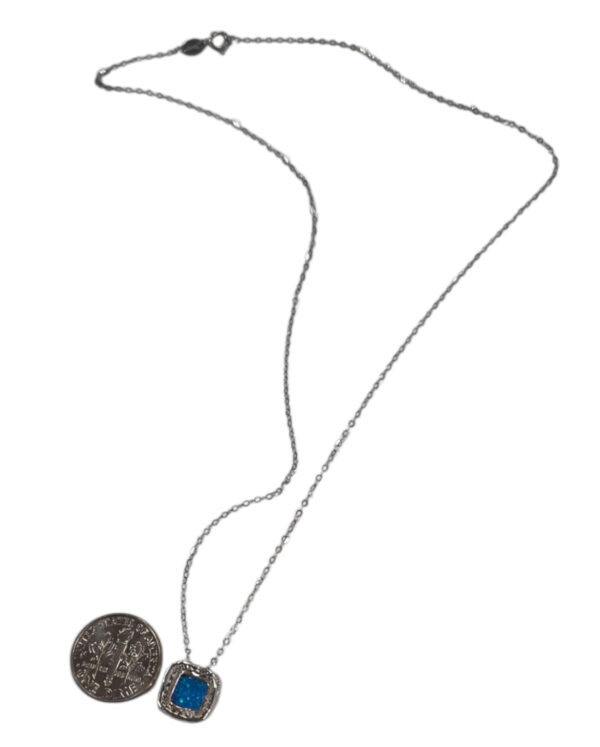 backside of created blue opal necklace with dime for scale
