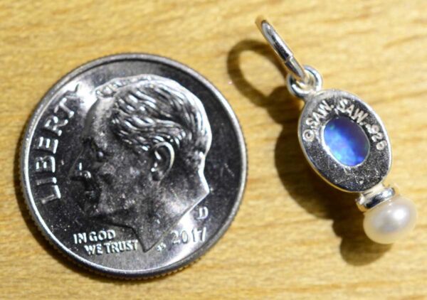 back of handmade created blue opal pendant with dime