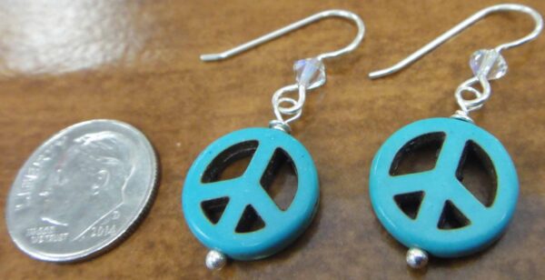 handmade blue peace sign earrings with dime for size