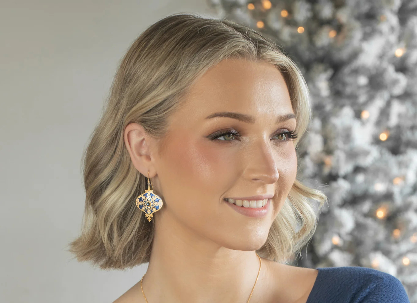 blue snowflake ornament earrings on model