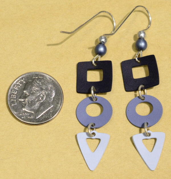 back of blue square circle and triangle Adajio earrings with dime