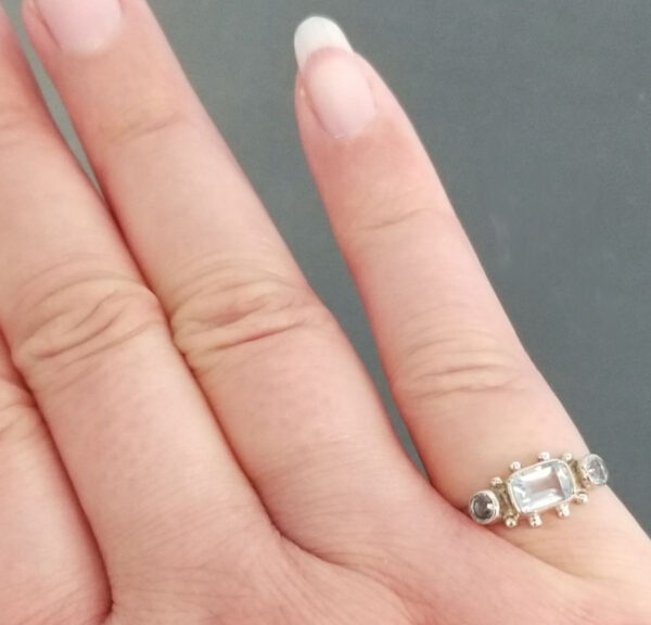 blue topaz and sterling silver ring on hand