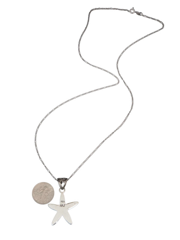 backside of starfish necklace with dime for size comparison