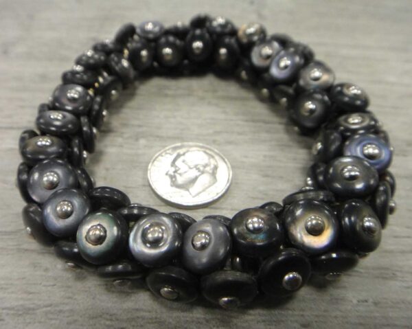 Handmade re-purposed Victorian era boot button bracelet shown with dime (not included) for size comparison