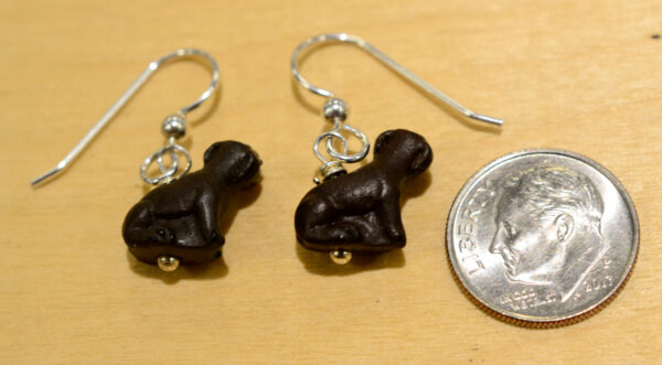 Back side of dark brown ceramic dog earrings, shown with dime (not included) for scale