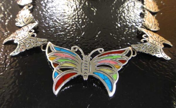 close up of detailed sterling silver and stone butterfly statement necklace