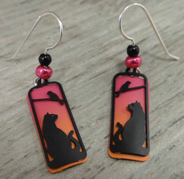 These cat and bird silhouette earrings are handmade by Sienna Sky and feature a sunset background.