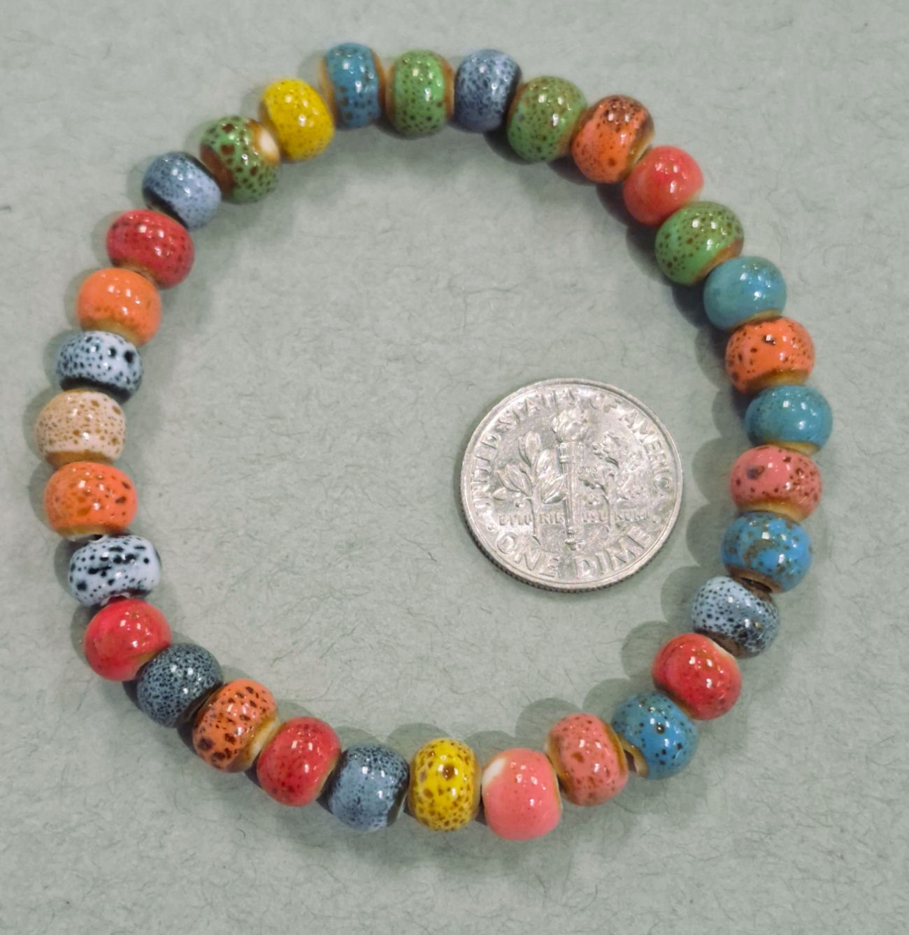 colorful ceramic bead bracelet with dime for size comparison