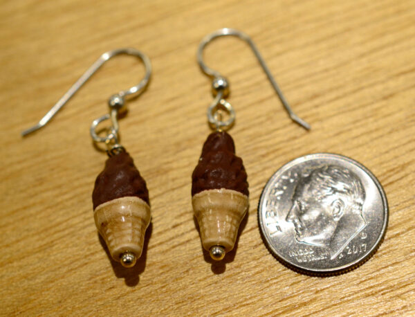 Handmade ceramic chocolate ice cream cone earrings, shown with dime (not included) for scale