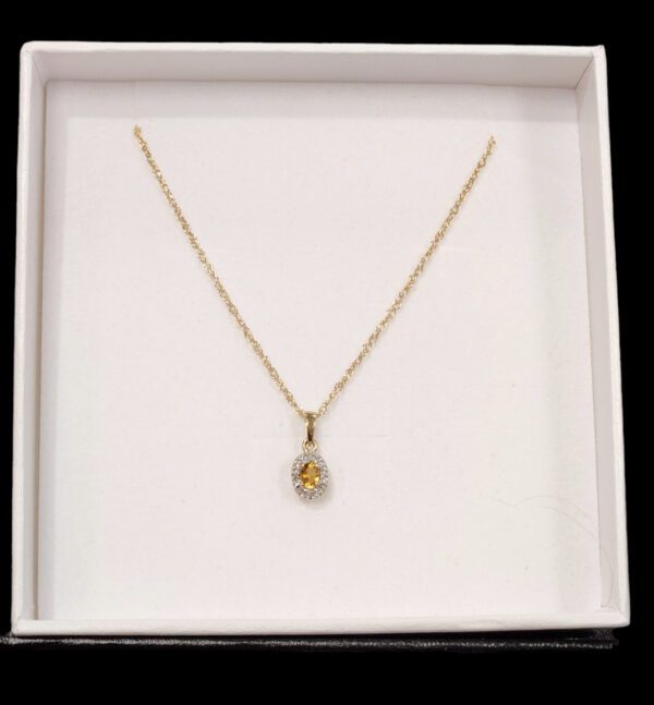 citrine, diamond, and gold necklace in gift box