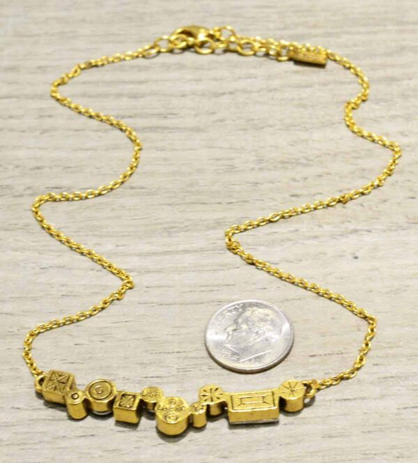 back of Danae two tone necklace by Patricia Locke with dime for size