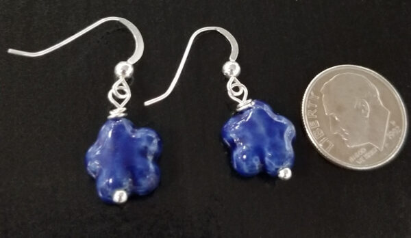 dark blue daisy earrings with dime for scale
