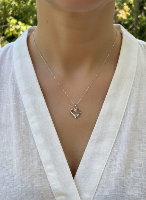 white gold and diamond dainty heart necklace on model